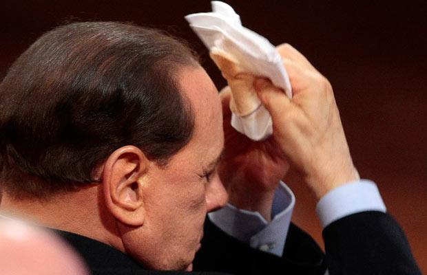 This picture from The Telegraph shows Berlusconi's make-up coming off as he mops his brow.