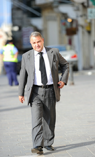 Inspector Gadget in full funeral gear and sorely in need of a new suit and aggressive diet