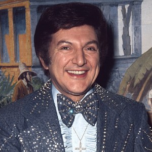 What else has he got in common with Liberace? The Manchester tan.