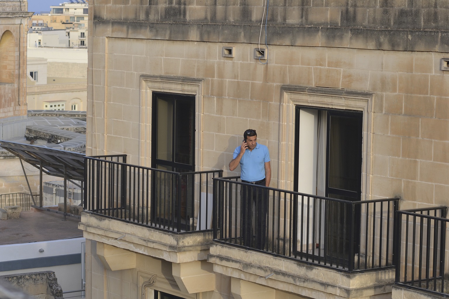 6.15pm - a police officer standing on the flat's balcony makes a call