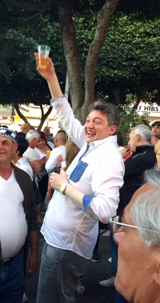 Health and Energy Minister Konrad Mizzi drinking in the street at a village feast
