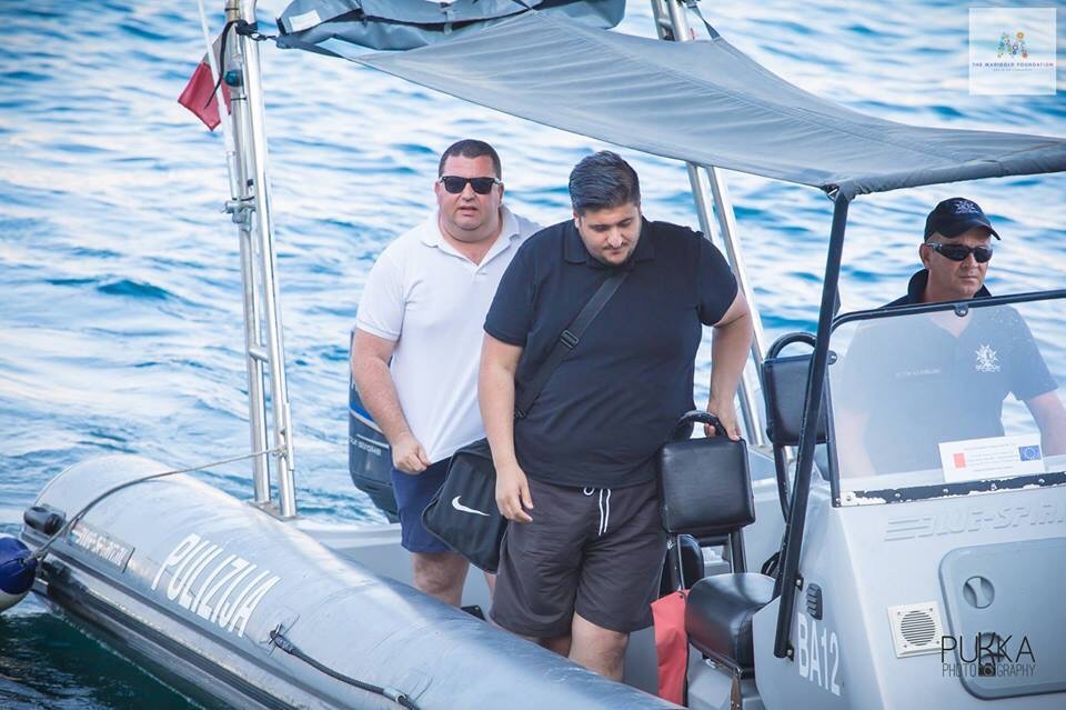 Two XXXXL men in a boat: Glenn Bedingfield (left), 42, and Luke Dalli, 28, are inseparable. They produce a Labour Party broadcast media show together and here they are closely observing the Prime Minister's wife as she swims "from Sawt to Porrrt"